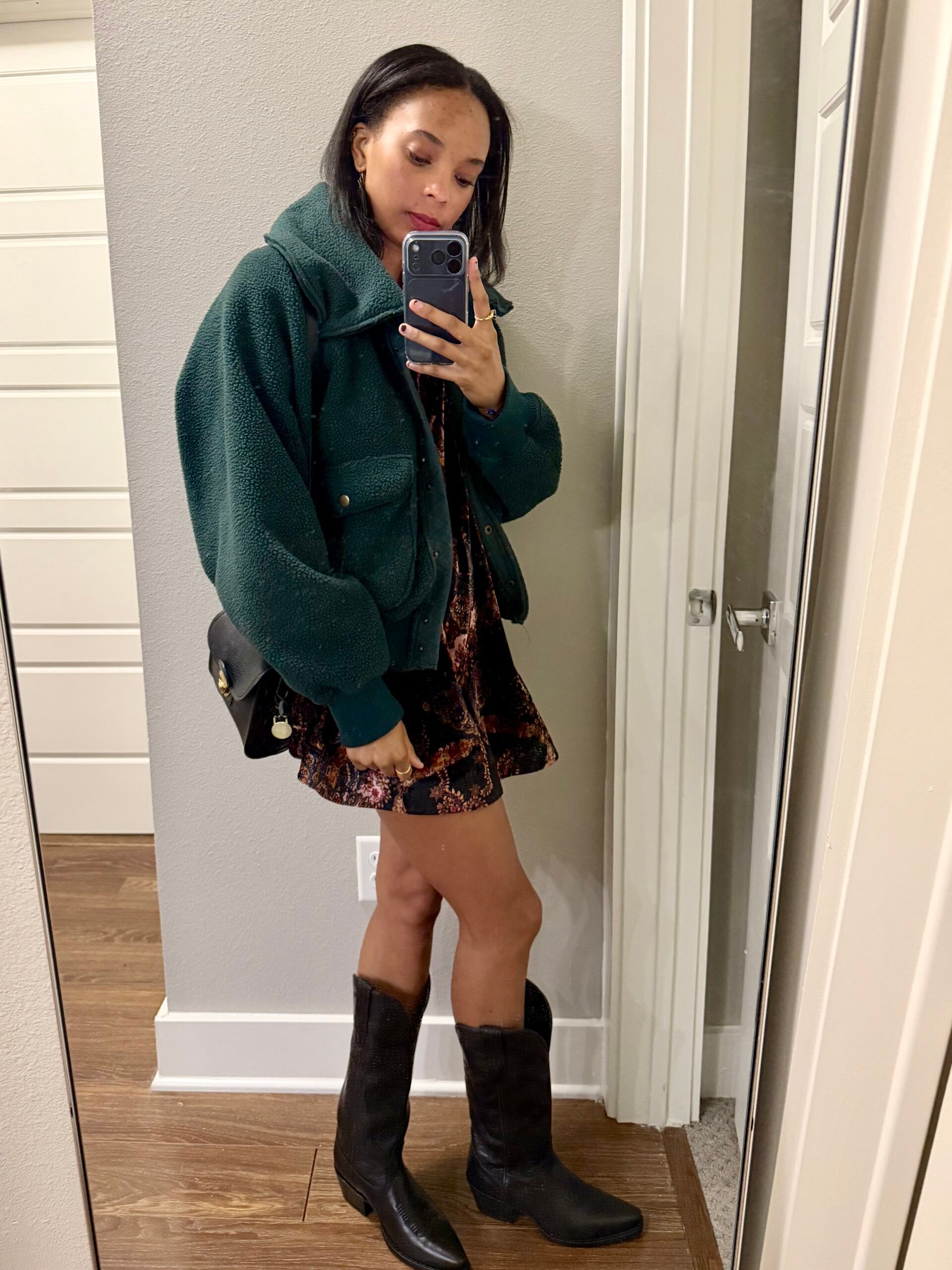 Layered birthday dinner outfit with a dress, jacket, and Tecovas boots